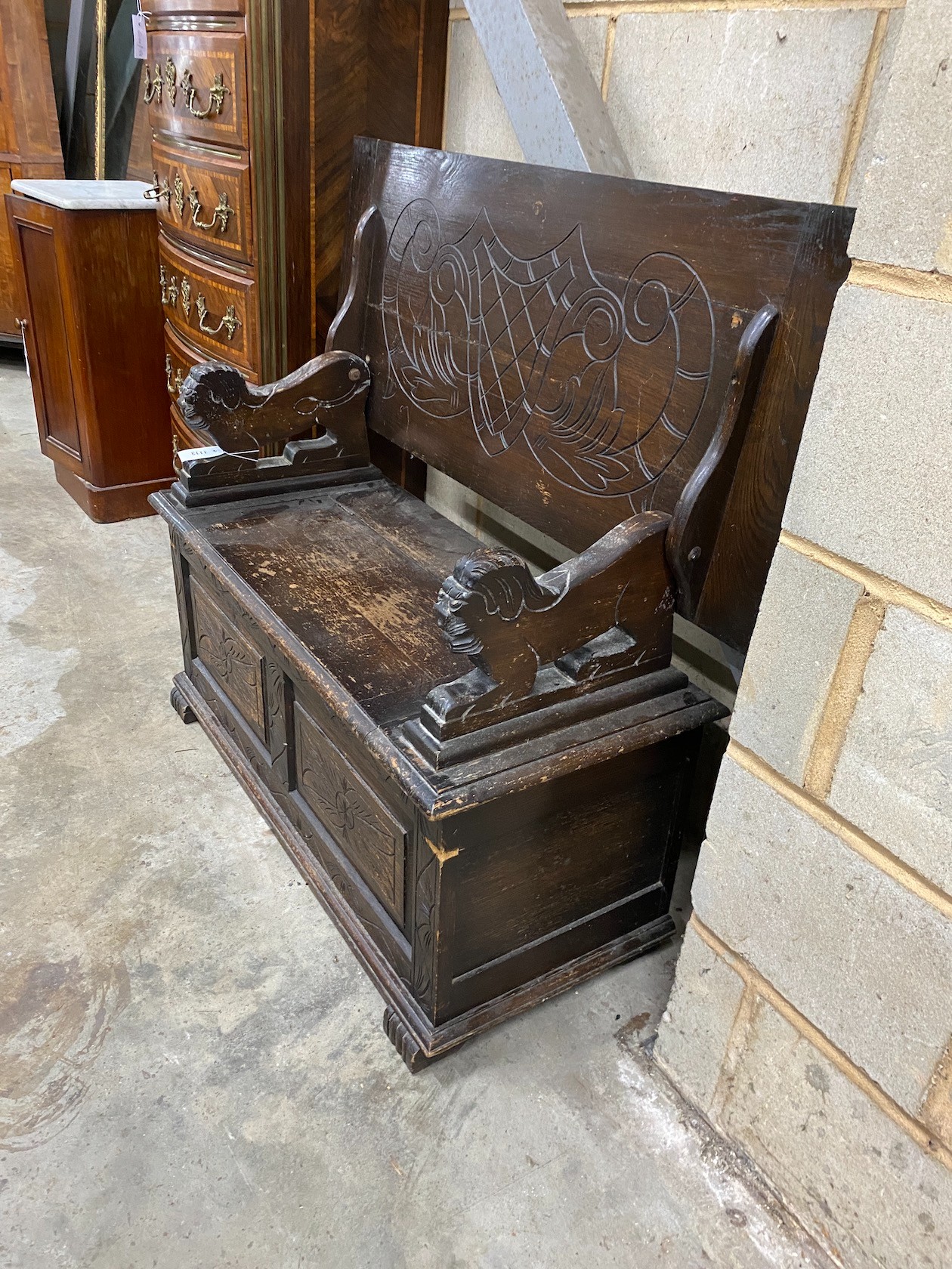 An early 20th century oak monk's bench, length 107cm, depth 45cm, height 67cm (closed)